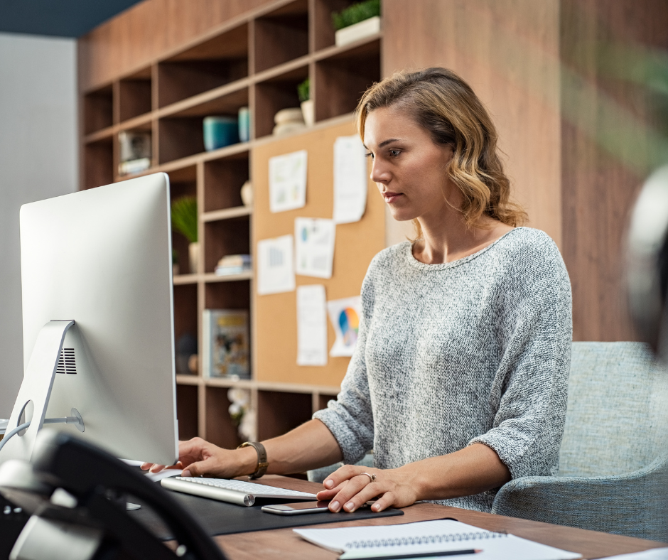 Woman in an office looking at her computer screen